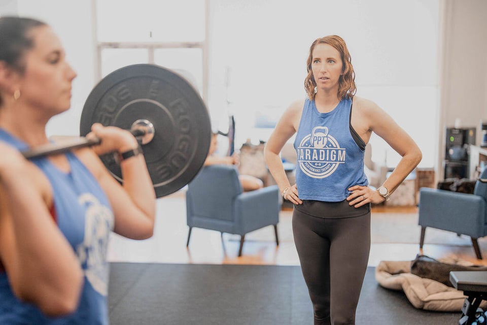 Dr. Colleen helping a patient with a sport specific exercise